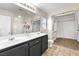 Bathroom with double sink vanity, tile floors, and separate closet space at 9527 Havasu Canyon Ave, Las Vegas, NV 89166