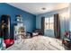 This bedroom features blue walls, and ample room for storage at 9527 Havasu Canyon Ave, Las Vegas, NV 89166