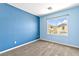 Blue bedroom featuring large window and neutral carpet floors at 9527 Havasu Canyon Ave, Las Vegas, NV 89166
