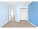 Blue bedroom featuring large closet, carpet floors and a view to the hallway at 9527 Havasu Canyon Ave, Las Vegas, NV 89166