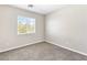 Bedroom featuring large window, carpet floors and neutral walls at 9527 Havasu Canyon Ave, Las Vegas, NV 89166