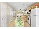 Bright kitchen with wooden cabinets, a granite island, stainless steel sink, and tile flooring at 9527 Havasu Canyon Ave, Las Vegas, NV 89166