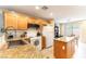 Bright kitchen features granite countertops, tile backsplash, oak cabinets, and updated appliances at 9527 Havasu Canyon Ave, Las Vegas, NV 89166