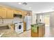 Well-lit kitchen with tile floors, honey-toned cabinetry, granite counters, and modern appliances at 9527 Havasu Canyon Ave, Las Vegas, NV 89166