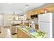 Updated kitchen with wooden cabinets, granite island, stainless steel sink, and natural light at 9527 Havasu Canyon Ave, Las Vegas, NV 89166