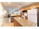 Updated kitchen featuring granite countertops, oak cabinets, stainless steel dishwasher, and modern appliances at 9527 Havasu Canyon Ave, Las Vegas, NV 89166