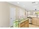 Kitchen with wooden cabinets, a granite island, and modern stainless steel appliances at 9527 Havasu Canyon Ave, Las Vegas, NV 89166