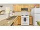 Charming kitchen featuring wooden cabinets, granite countertops, and a stylish tile backsplash at 9527 Havasu Canyon Ave, Las Vegas, NV 89166