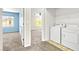 Second floor laundry area has a washer and dryer with an open view to a blue bedroom at 9527 Havasu Canyon Ave, Las Vegas, NV 89166