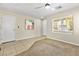 Open living area with neutral paint, mixed flooring, bright windows and ceiling fan at 9527 Havasu Canyon Ave, Las Vegas, NV 89166