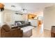 Cozy living room featuring tile flooring, a ceiling fan, and neutral paint that connects to the kitchen at 9527 Havasu Canyon Ave, Las Vegas, NV 89166