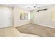 Cozy living room featuring neutral paint, large windows, ceiling fan, and mixed flooring at 9527 Havasu Canyon Ave, Las Vegas, NV 89166