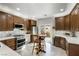 Bright kitchen featuring wooden cabinetry, modern appliances, and a sliding door to the backyard at 9533 Solitude Canyon Ave, Las Vegas, NV 89149