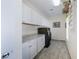 Well-organized laundry room with ample cabinet space, modern washer, and dryer at 9533 Solitude Canyon Ave, Las Vegas, NV 89149