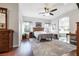 Bright main bedroom with wood bed frame, sitting area with soaking tub, and hardwood floors at 9533 Solitude Canyon Ave, Las Vegas, NV 89149