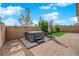 A well-maintained backyard featuring a hot tub, brick pavers, and manicured greenery at 9795 Bold Skye Ave, Las Vegas, NV 89166