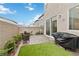 Small backyard with pavers, synthetic grass, grill and comfortable seating at 10190 Natural Anchor St, Las Vegas, NV 89166