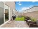 Cozy backyard with stone patio, turf, and seating area with outdoor furniture at 10190 Natural Anchor St, Las Vegas, NV 89166