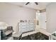 Neutral bedroom with ceiling fan features walk in closet and ensuite bathroom at 10190 Natural Anchor St, Las Vegas, NV 89166