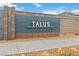 Elegant community entrance sign with modern design, set against a backdrop of manicured landscaping at 10190 Natural Anchor St, Las Vegas, NV 89166