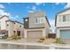 Two-story home with a contemporary exterior, a two-car garage, and a paved driveway, complimented by desert landscaping at 10190 Natural Anchor St, Las Vegas, NV 89166