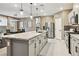 Spacious kitchen featuring a large island, stainless steel appliances, and an adjacent dining area for seamless entertaining at 10190 Natural Anchor St, Las Vegas, NV 89166