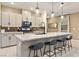 Stylish kitchen with a granite island, bar stool seating, and pendant lighting, perfect for modern living at 10190 Natural Anchor St, Las Vegas, NV 89166