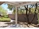 Relaxing covered patio with a view of the backyard and mature trees at 10239 Premia Pl, Las Vegas, NV 89135