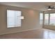 Bright and airy sitting room with tiled floor, many windows with blinds, and a ceiling fan at 10239 Premia Pl, Las Vegas, NV 89135