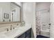 Bathroom featuring dark vanity with silver fixtures, shower-tub combo, and tile flooring at 1049 Via Saint Lucia Pl, Henderson, NV 89011