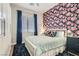 Bedroom featuring colorful wallpaper, wood floors, a ceiling fan, and lots of natural light at 1049 Via Saint Lucia Pl, Henderson, NV 89011