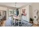 Elegant dining area with a white table, seating for six, and built-in cabinets at 1049 Via Saint Lucia Pl, Henderson, NV 89011