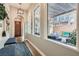 Bright entryway with wood floors, bench seating, and a view of the outdoor patio through large windows at 1049 Via Saint Lucia Pl, Henderson, NV 89011