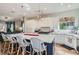 Open-concept kitchen with counter seating flowing seamlessly into the living area at 1049 Via Saint Lucia Pl, Henderson, NV 89011