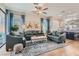 Open-concept living room with plush seating and natural light flowing into the kitchen at 1049 Via Saint Lucia Pl, Henderson, NV 89011