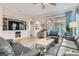 Cozy living room with built-in shelving, comfortable seating, and access to the outdoor patio at 1049 Via Saint Lucia Pl, Henderson, NV 89011