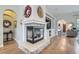 Cozy living room with a modern fireplace, built-in shelving, and hardwood floors at 1049 Via Saint Lucia Pl, Henderson, NV 89011