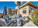 Charming outdoor patio area with comfortable seating, fire pit, and access to the backyard at 1049 Via Saint Lucia Pl, Henderson, NV 89011