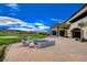 Luxury home's outdoor living space with a fire pit, comfortable seating, and golf course views at 116 Juliette Pointe Ln, Henderson, NV 89011