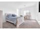 Neutral bedroom boasts a queen bed with a blue comforter and matching dresser at 116 Juliette Pointe Ln, Henderson, NV 89011