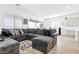 Cozy living room with lots of natural light, a large couch, and hardwood floors at 116 Juliette Pointe Ln, Henderson, NV 89011