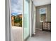 Balcony view of desert landscape, neighboring rooftops, and a window into the bedroom at 12240 Old Muirfield St, Las Vegas, NV 89141