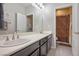 Bright bathroom featuring dual sinks, a large mirror, and a separate toilet/shower area for convenience at 12240 Old Muirfield St, Las Vegas, NV 89141