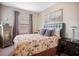 Cozy bedroom featuring neutral walls, carpet and a large window for ample natural lighting at 12240 Old Muirfield St, Las Vegas, NV 89141