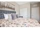 Comfortable bedroom with plush bedding, neutral walls, and ample closet space for storage at 12240 Old Muirfield St, Las Vegas, NV 89141