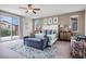 Bright bedroom featuring ceiling fan, patterned rug, and sliding glass doors at 12240 Old Muirfield St, Las Vegas, NV 89141