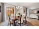 This dining room has a wood table with seating for six, a chandelier, and sliding doors at 12240 Old Muirfield St, Las Vegas, NV 89141