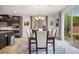 This dining room has a dark wood table with seating for six and sliding doors to the backyard at 12240 Old Muirfield St, Las Vegas, NV 89141