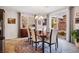Bright dining room features a decorative chandelier, a dark wood table, and access to the backyard at 12240 Old Muirfield St, Las Vegas, NV 89141