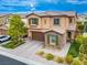 Charming two-story home featuring a well-maintained yard, stone accents, and an attached two-car garage at 12240 Old Muirfield St, Las Vegas, NV 89141